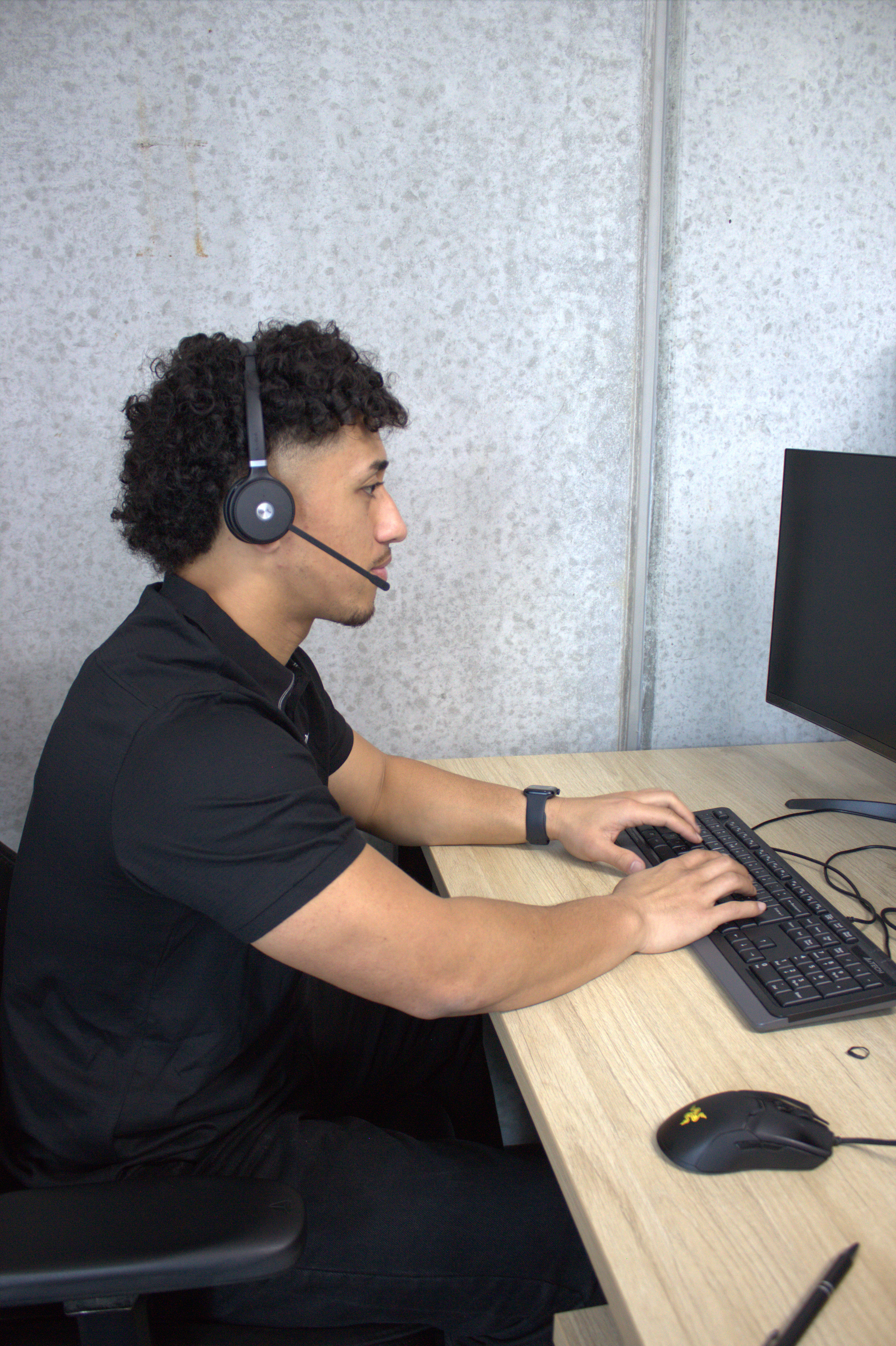 BC Security operator with headset working at a remote monitoring desk