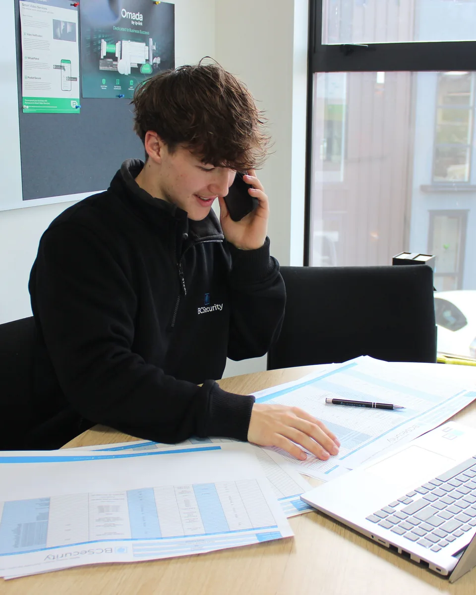 Security planning review with site drawings and a laptop