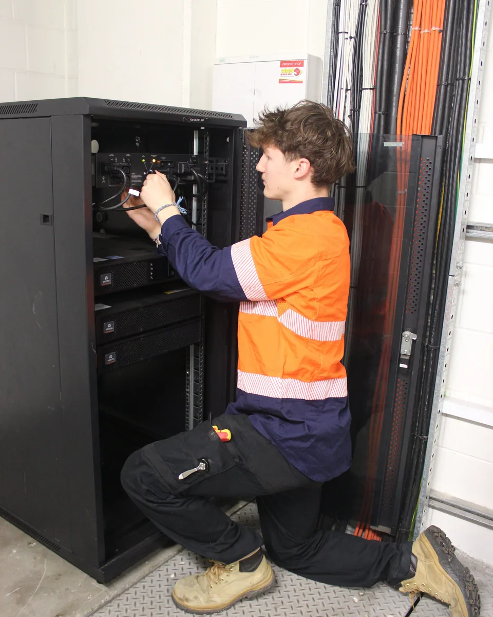 Technician working on rack equipment during an upgrade