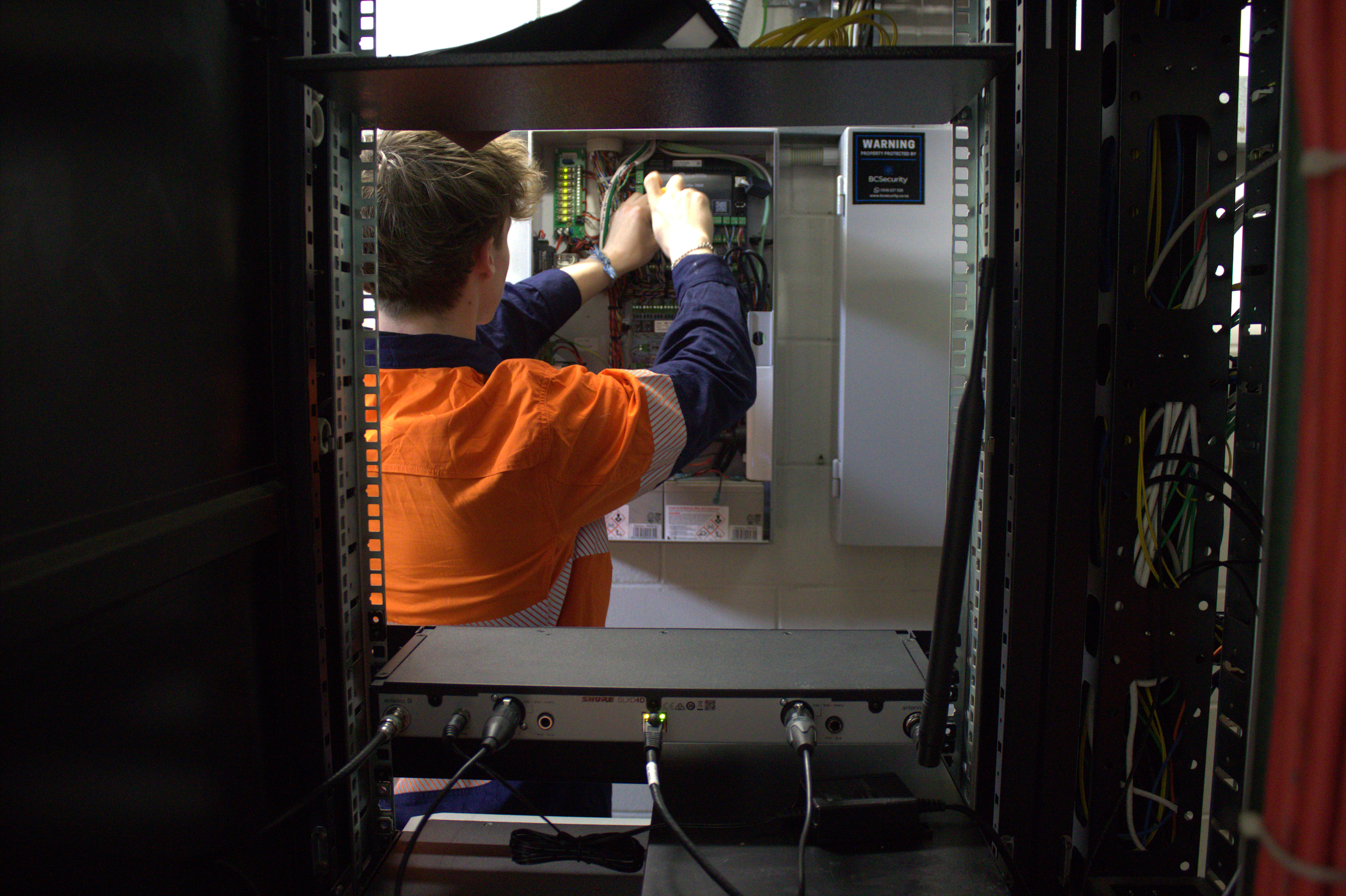 Technician installing a security control panel on site