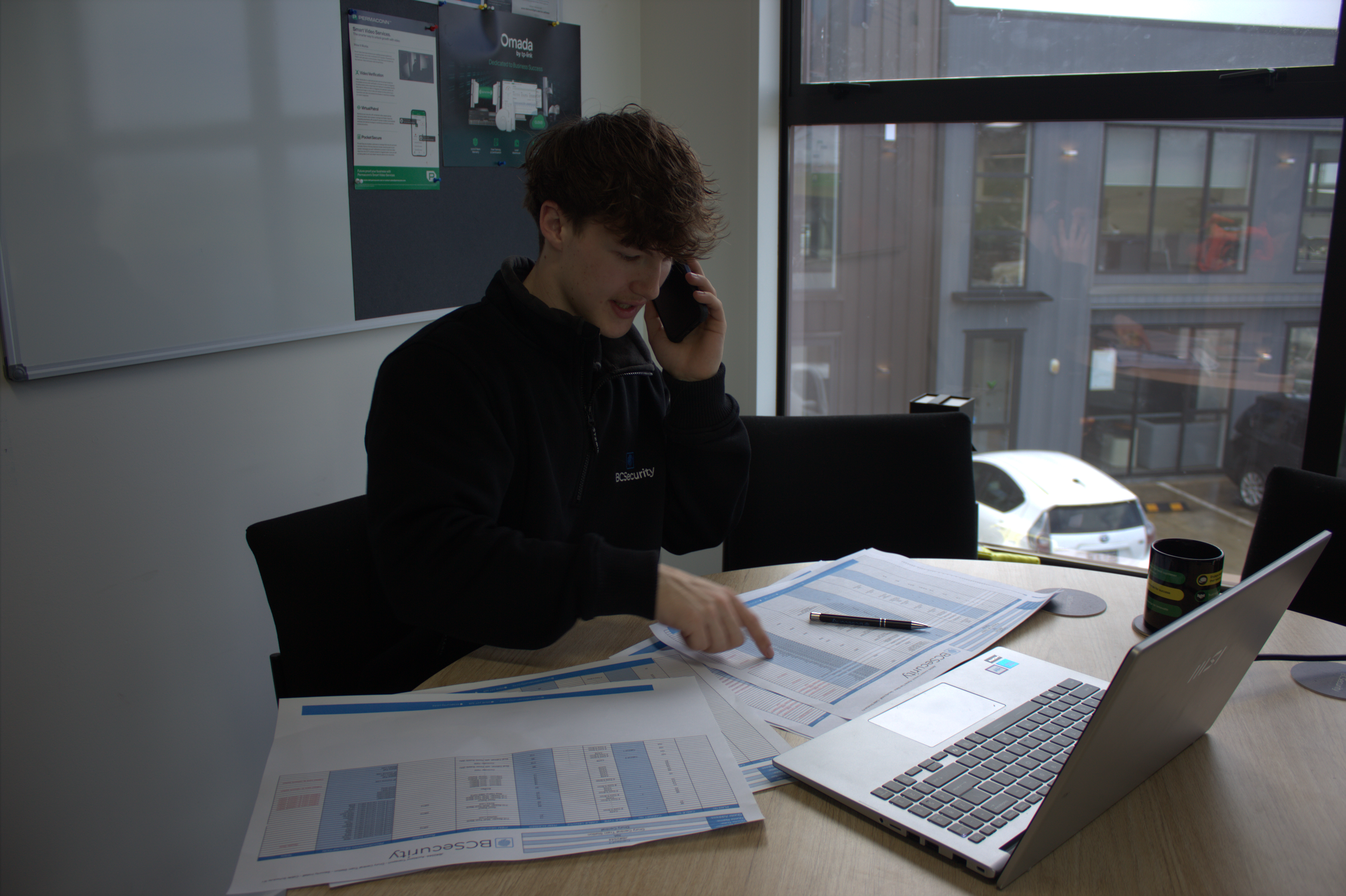 Security planning review with site documentation and laptop