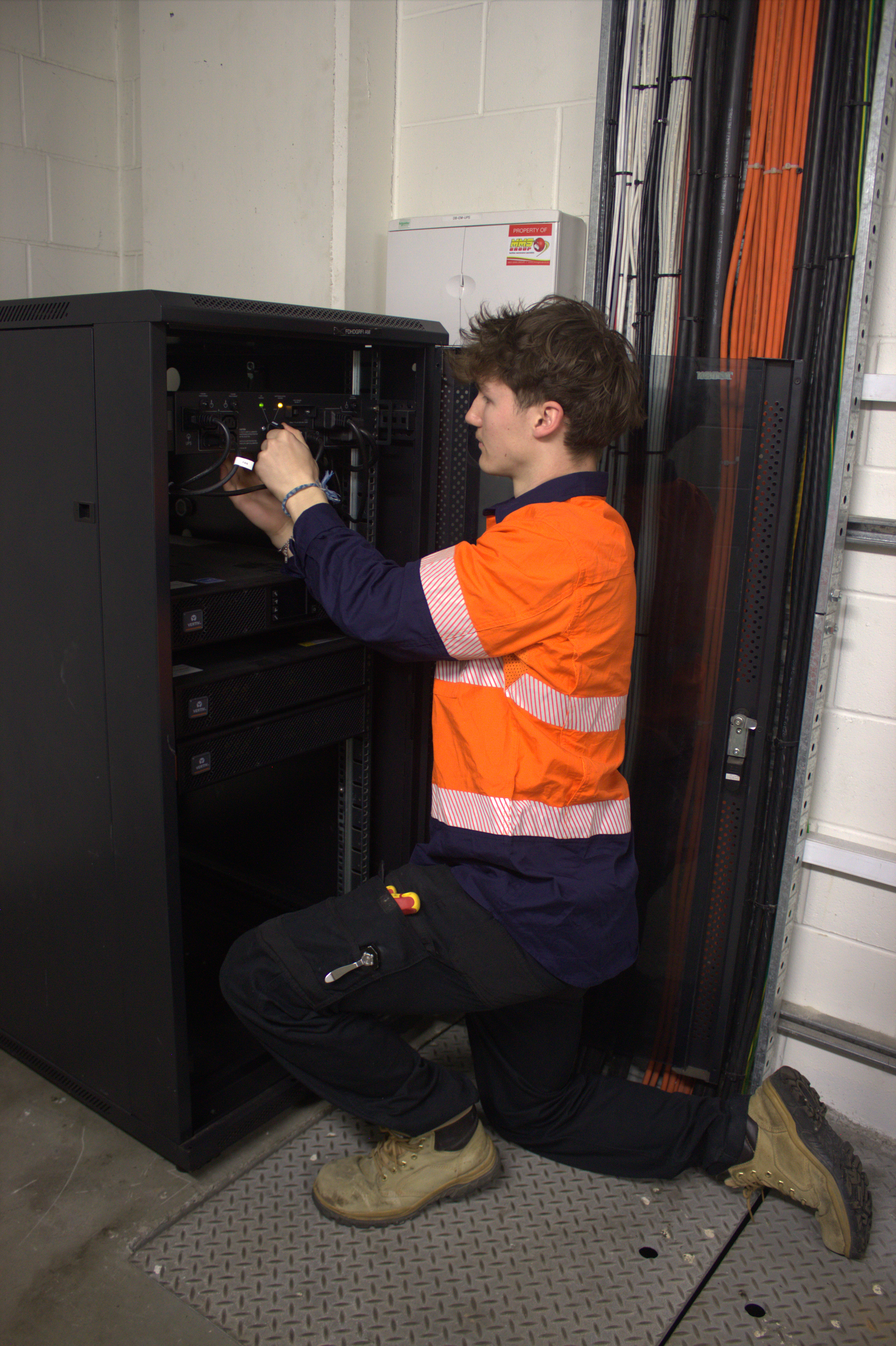 Technician working on rack equipment during an upgrade
