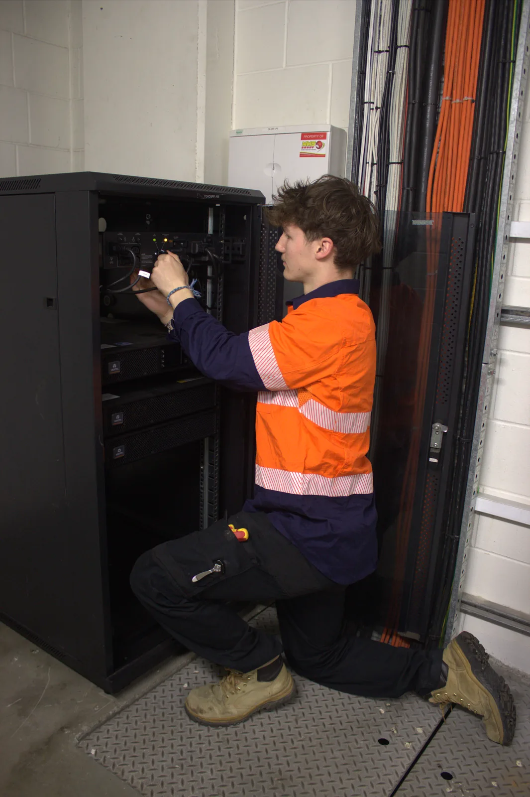 Technician working on rack equipment during an upgrade